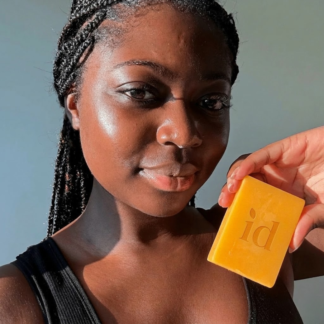 NAIA Turmeric Fade & Glow Bar, natural skincare soap with turmeric, shown in a close-up image highlighting its texture and packaging.